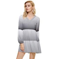 A Black And White Photo Of A Wall Tiered Long Sleeve Mini Dress