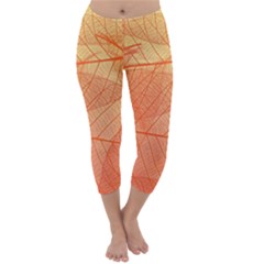 Abstract Texture Of Colorful Bright Pattern Of Transparent Leaves Of Orange And Yellow Color Capri Winter Leggings  by Posterlux