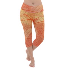 Abstract Texture Of Colorful Bright Pattern Of Transparent Leaves Of Orange And Yellow Color Lightweight Velour Capri Yoga Leggings by Posterlux