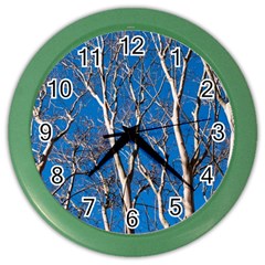 Trees On Blue Sky Colored Wall Clock by Elanga