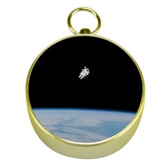 Astronaut Floating Above The Blue Planet Gold Compasses by Nexatart